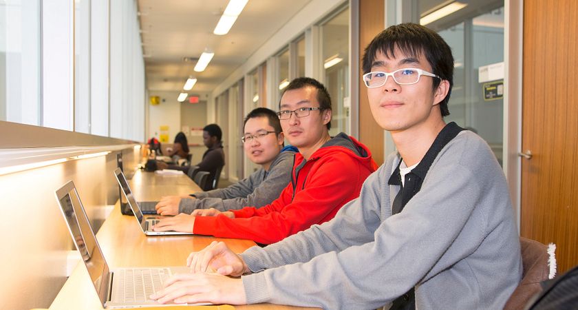 Centennial College students studying together in the library.